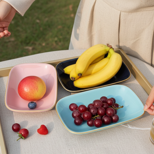 Tray with colorful bowls containing fruits on a light surface.